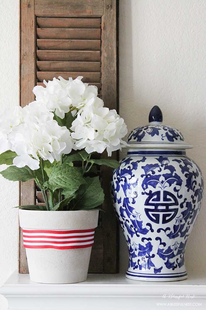 I adore the vintage Americana 4th of July mantle decor! With pops of aqua this is the perfect 4th of July decor by A Blissful Nest. https://ablisfulnest.com #4thofjuly #redwhiteandblue #4thofjulydecor