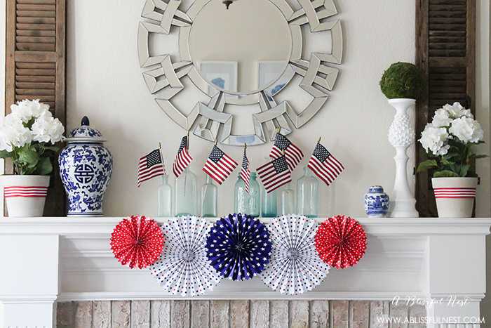 I adore the vintage Americana 4th of July mantle decor! With pops of aqua this is the perfect 4th of July decor by A Blissful Nest. https://ablisfulnest.com #4thofjuly #redwhiteandblue #4thofjulydecor