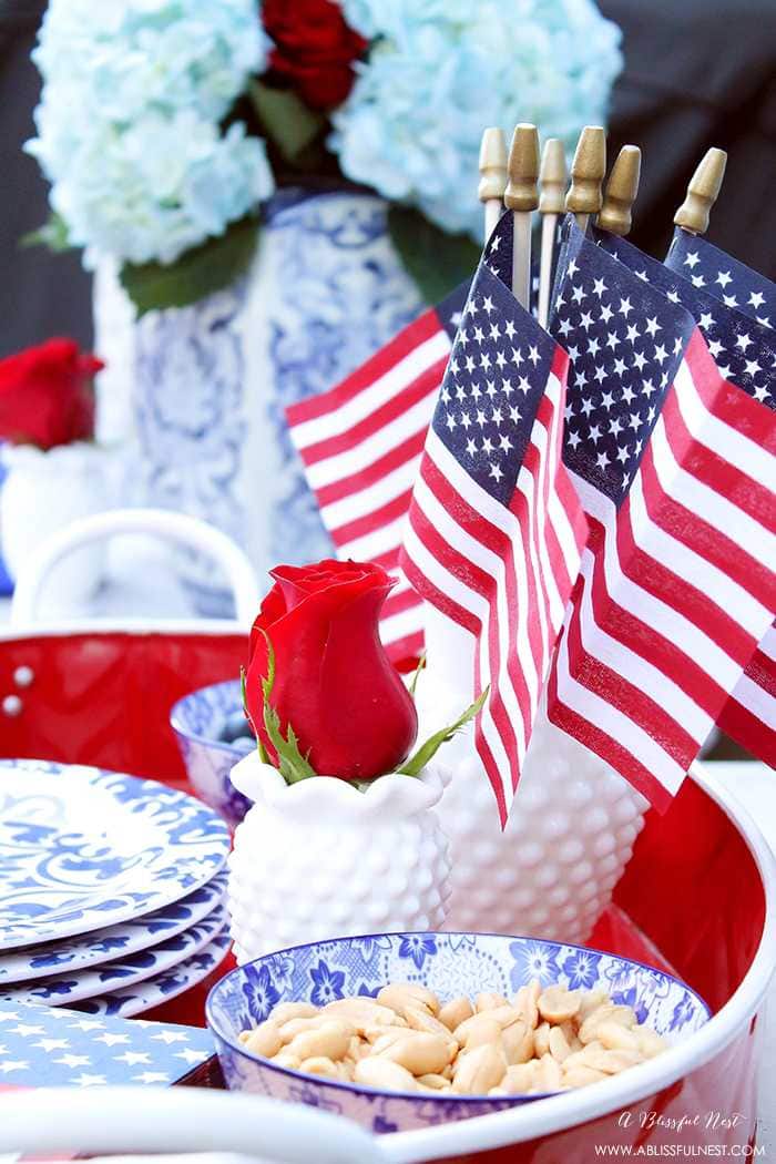 These are such great ideas to celebrate 4th of July with! I love all the Americana red, white and blue pops of color on this patio. Check out more on A Blissful Nest. https://ablisfulnest.com #4thofjuly #4thofjulydecor #redwhiteandblue