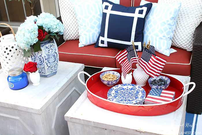 These are such great ideas to celebrate 4th of July with! I love all the Americana red, white and blue pops of color on this patio. Check out more on A Blissful Nest. https://ablisfulnest.com #4thofjuly #4thofjulydecor #redwhiteandblue