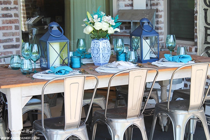 Fresh coastal table décor ideas for the perfect summer night. Grab these tips on setting the perfect coastal tablescape by A Blissful Nest. https://ablisfulnest.com/ #coastal #tabledecor #tabledecorideas #coastalinteriors #coastalroom #ocean #blueandwhite