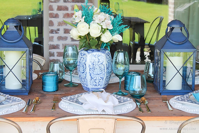 Fresh coastal table décor ideas for the perfect summer night. Grab these tips on setting the perfect coastal tablescape by A Blissful Nest. https://ablisfulnest.com/ #coastal #tabledecor #tabledecorideas #coastalinteriors #coastalroom #ocean #blueandwhite