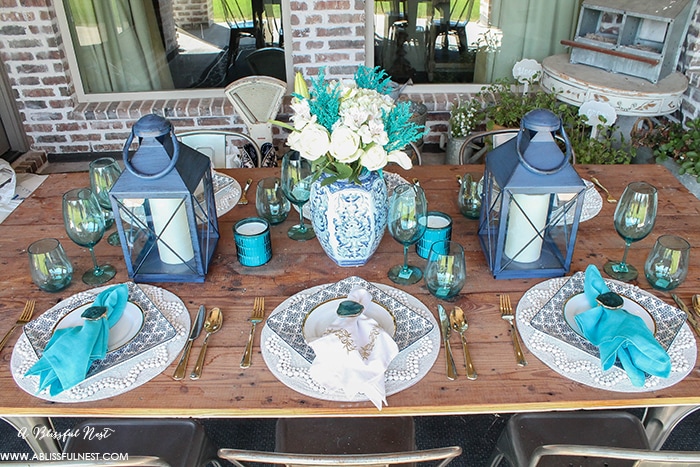 Fresh coastal table décor ideas for the perfect summer night. Grab these tips on setting the perfect coastal tablescape by A Blissful Nest. https://ablisfulnest.com/ #coastal #tabledecor #tabledecorideas #coastalinteriors #coastalroom #ocean #blueandwhite