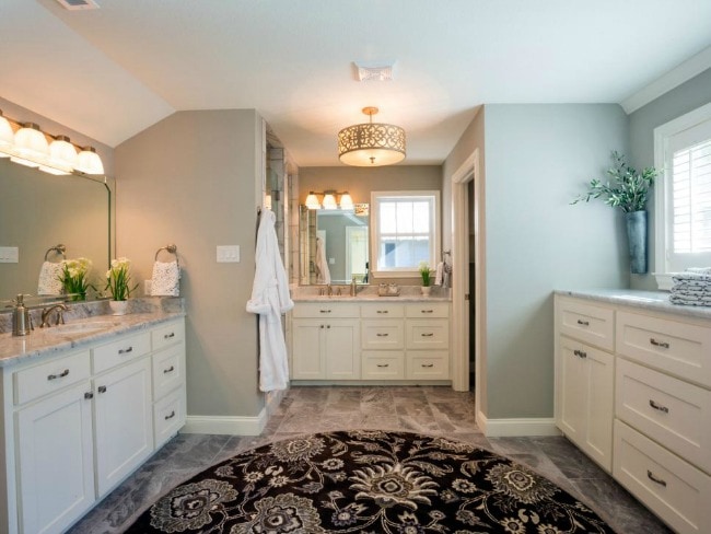This spacious bathroom is light and bright with natural light and stunning blue gray walls. HGTV Bathroom Flips, 20 Best Fixer Upper Rooms 