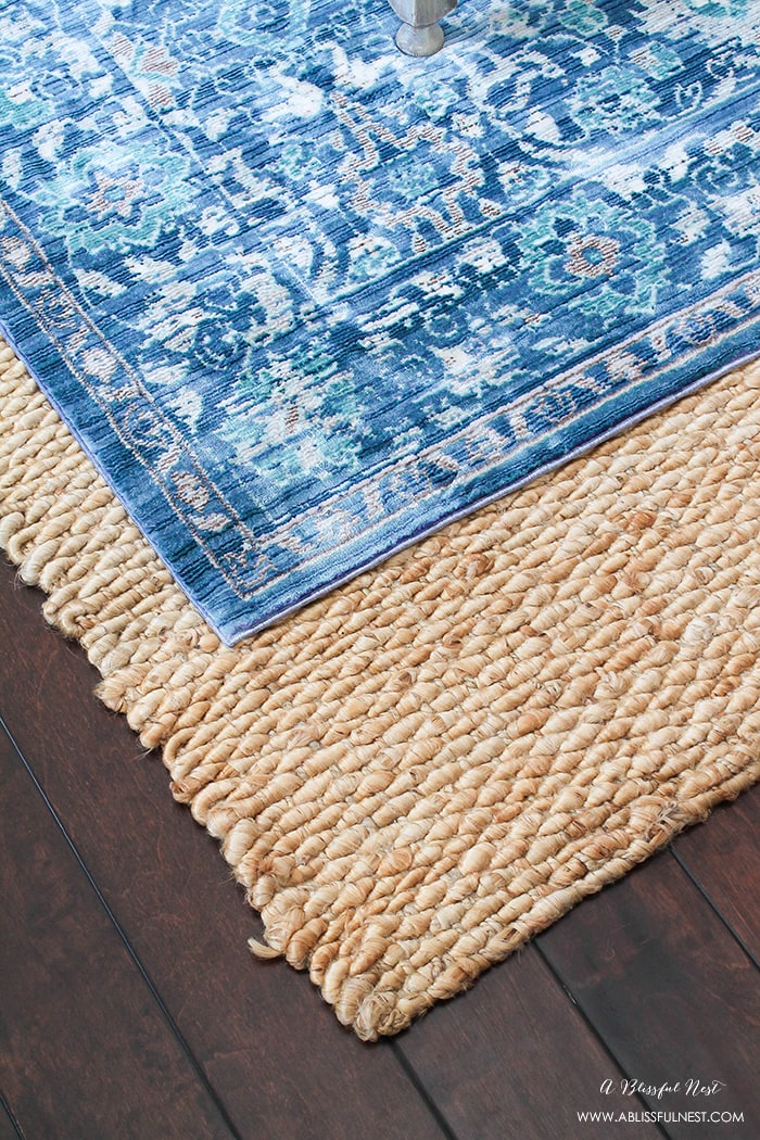 It’s time for a change! Show some designer flare and learn how to layer rugs like a pro. The designers all do it for a reason. It makes BIG impact. Make your room pop with these 5 simple tips from A Blissful Nest. https://ablisfulnest.com/ #rugideas #designtips #homedecortips #livingroom #livingroomideas
