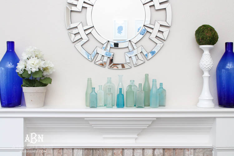 Such an easy tutorial on how to create DIY sea glass bottles using spray paint. Literally 2 steps to get this coastal décor look! See how on https://ablisfulnest.com/ #coastaldecorating #seaglassbottle #designtips #howtomake #diyseaglassbottles