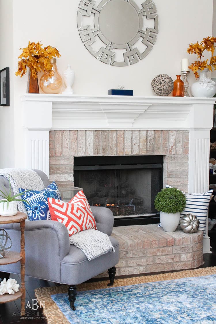 Check out these gorgeous coastal accents in this fall home tour with A Blissful Nest! Love the pops of orange in this home with its neutral pallet. See more at https://ablisfulnest.com/ #fallfrontporch #falldecorating #falldecor #fallhometour