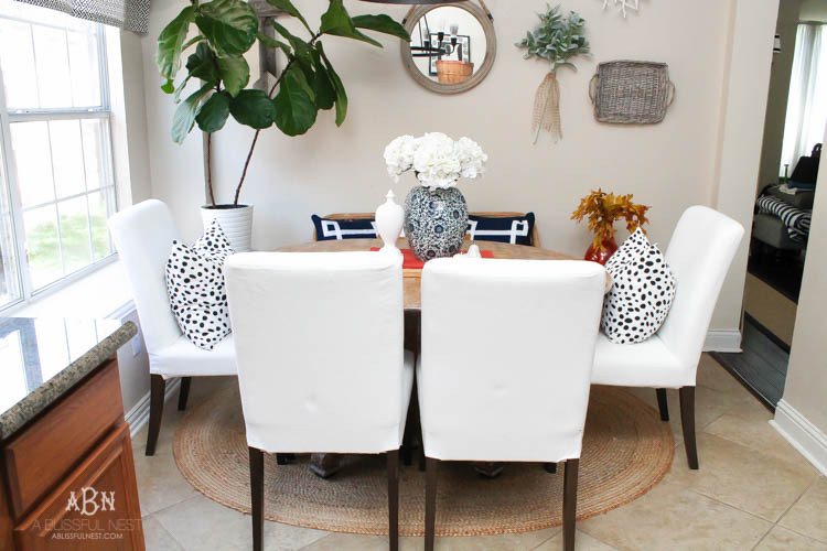 Check out these gorgeous coastal accents in this fall home tour with A Blissful Nest! Love the pops of orange in this home with its neutral pallet. See more at https://ablisfulnest.com/ #fallfrontporch #falldecorating #falldecor #fallhometour