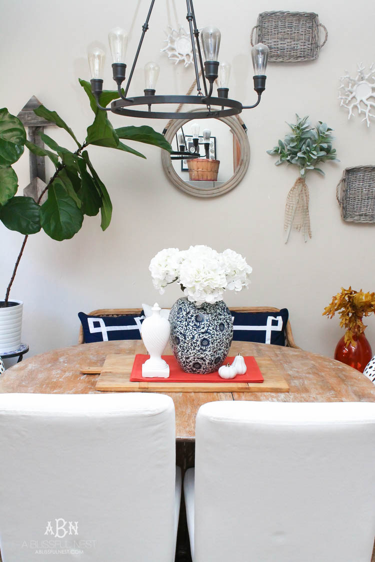 Check out these gorgeous coastal accents in this fall home tour with A Blissful Nest! Love the pops of orange in this home with its neutral pallet. See more at https://ablisfulnest.com/ #fallfrontporch #falldecorating #falldecor #fallhometour