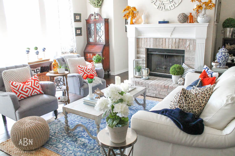 Check out these gorgeous coastal accents in this fall home tour with A Blissful Nest! Love the pops of orange in this home with its neutral pallet. See more at https://ablisfulnest.com/ #fallfrontporch #falldecorating #falldecor #fallhometour