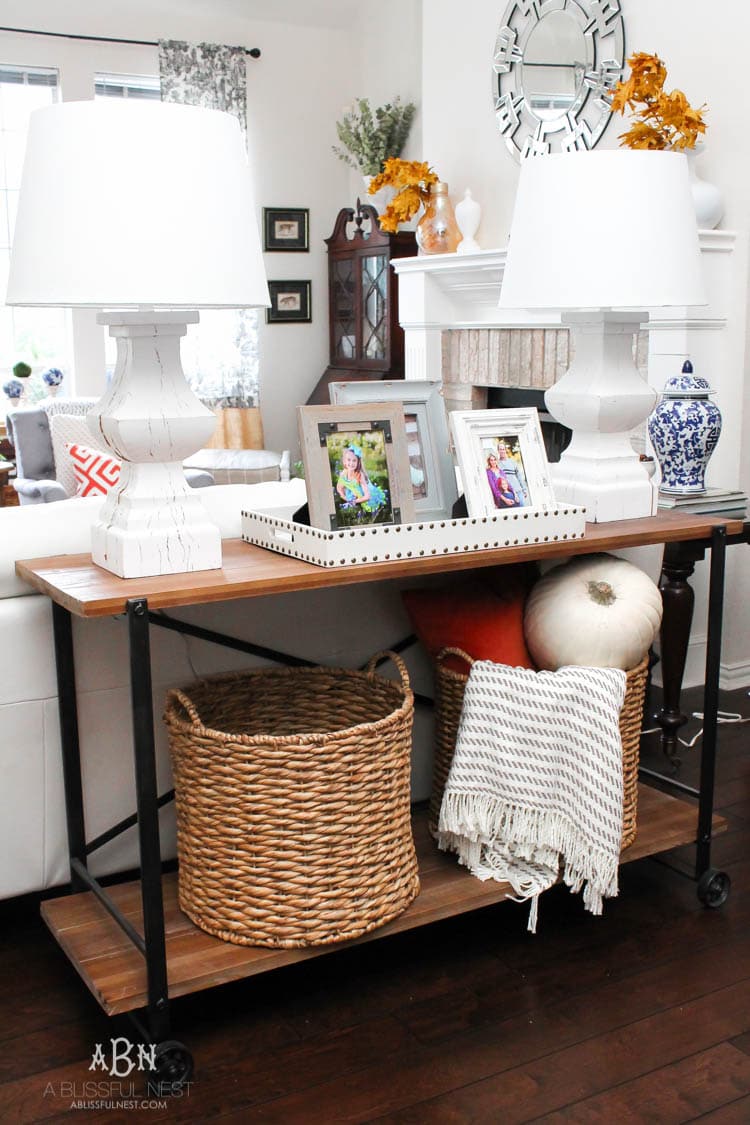Check out these gorgeous coastal accents in this fall home tour with A Blissful Nest! Love the pops of orange in this home with its neutral pallet. See more at https://ablisfulnest.com/ #fallfrontporch #falldecorating #falldecor #fallhometour