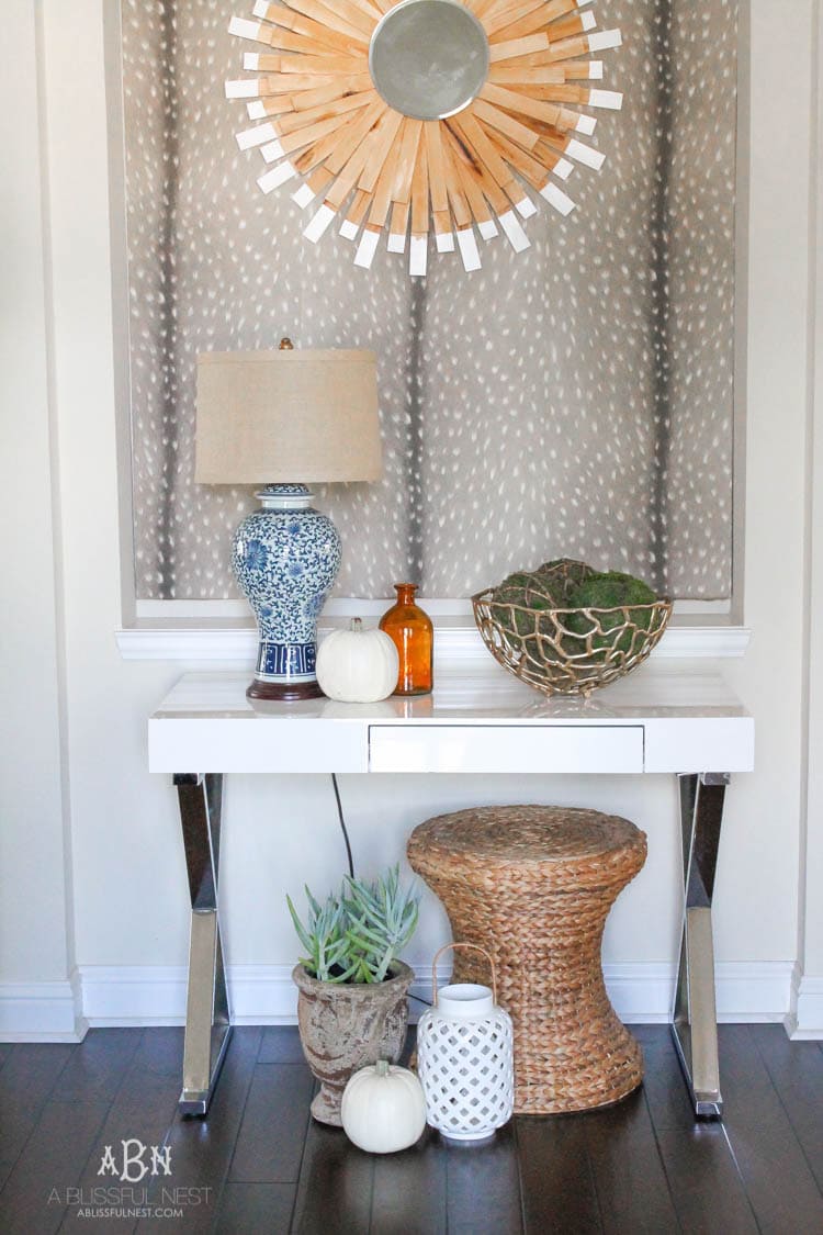 Check out these gorgeous coastal accents in this fall home tour with A Blissful Nest! Love the pops of orange in this home with its neutral pallet. See more at https://ablisfulnest.com/ #fallfrontporch #falldecorating #falldecor #fallhometour