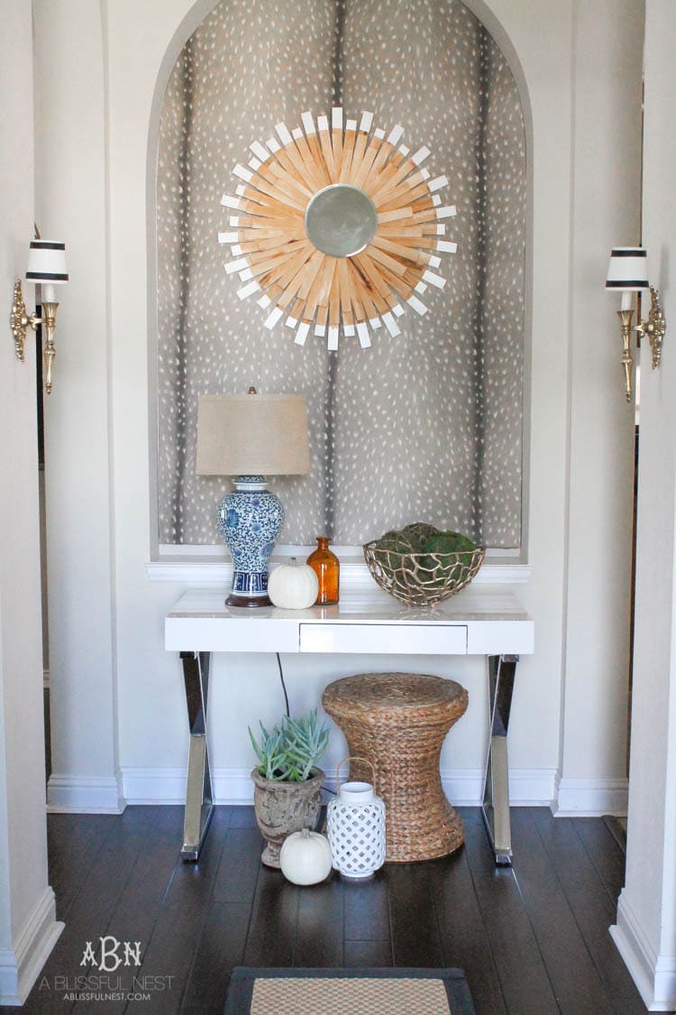 Check out these gorgeous coastal accents in this fall home tour with A Blissful Nest! Love the pops of orange in this home with its neutral pallet. See more at https://ablisfulnest.com/ #fallfrontporch #falldecorating #falldecor #fallhometour