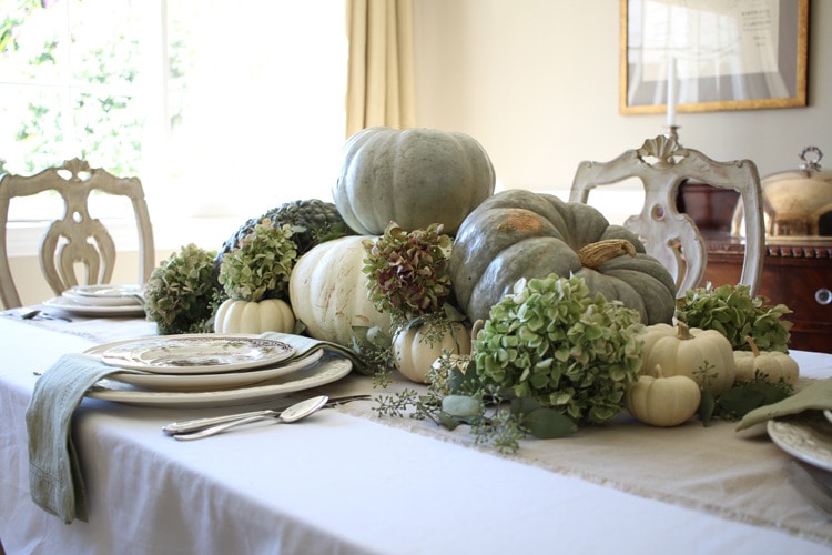 This neutral Fall tablescape is full of natural elements, brown toile dishes and loads of pumpkins and dried florals. Visit https://ablisfulnest.com/ for all of the details! #NeutralDecor #Fall #FallTablescape