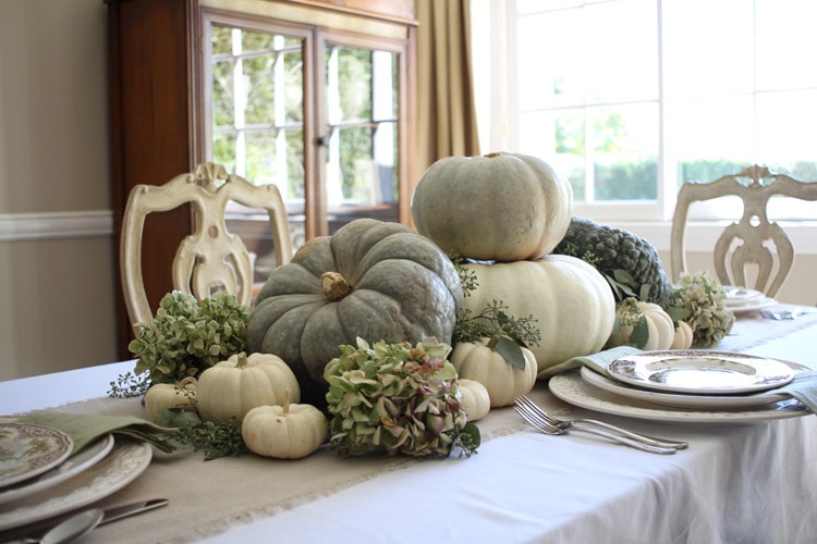 This neutral Fall tablescape is full of natural elements, brown toile dishes and loads of pumpkins and dried florals. Visit https://ablisfulnest.com/ for all of the details! #NeutralDecor #Fall #FallTablescape
