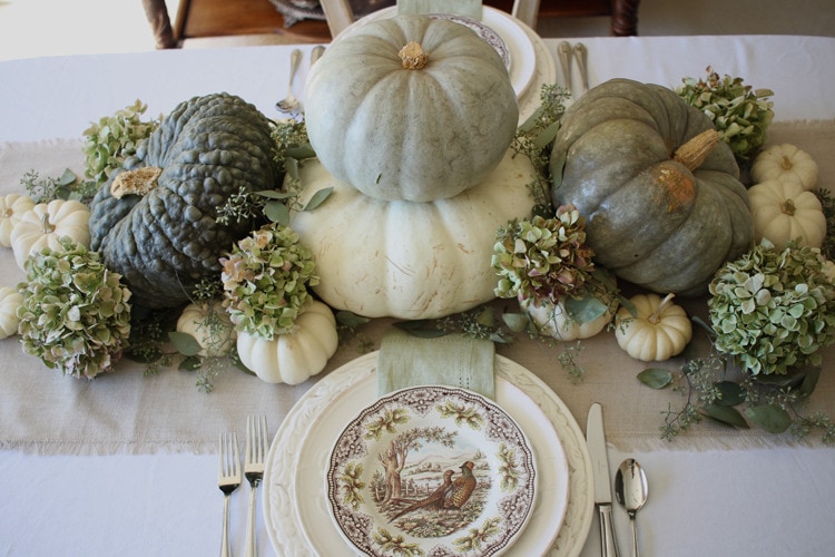 This neutral Fall tablescape is full of natural elements, brown toile dishes and loads of pumpkins and dried florals. Visit https://ablisfulnest.com/ for all of the details! #NeutralDecor #Fall #FallTablescape