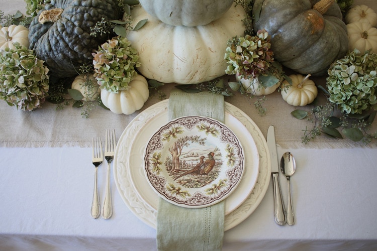 This neutral Fall tablescape is full of natural elements, brown toile dishes and loads of pumpkins and dried florals. Visit https://ablisfulnest.com/ for all of the details! #NeutralDecor #Fall #FallTablescape