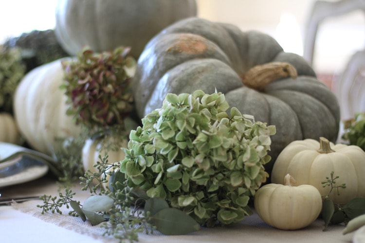 This neutral Fall tablescape is full of natural elements, brown toile dishes and loads of pumpkins and dried florals. Visit https://ablisfulnest.com/ for all of the details! #NeutralDecor #Fall #FallTablescape