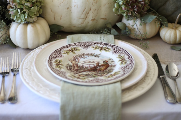 This neutral Fall tablescape is full of natural elements, brown toile dishes and loads of pumpkins and dried florals. Visit https://ablisfulnest.com/ for all of the details! #NeutralDecor #Fall #FallTablescape