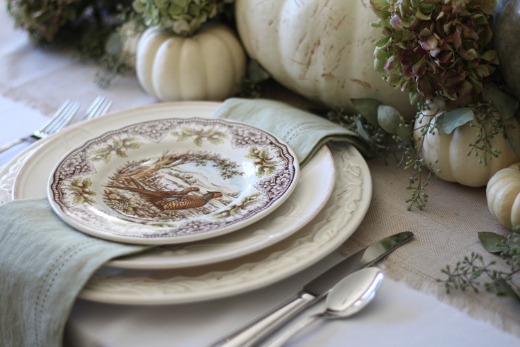 This neutral Fall tablescape is full of natural elements, brown toile dishes and loads of pumpkins and dried florals. Visit https://ablisfulnest.com/ for all of the details! #NeutralDecor #Fall #FallTablescape