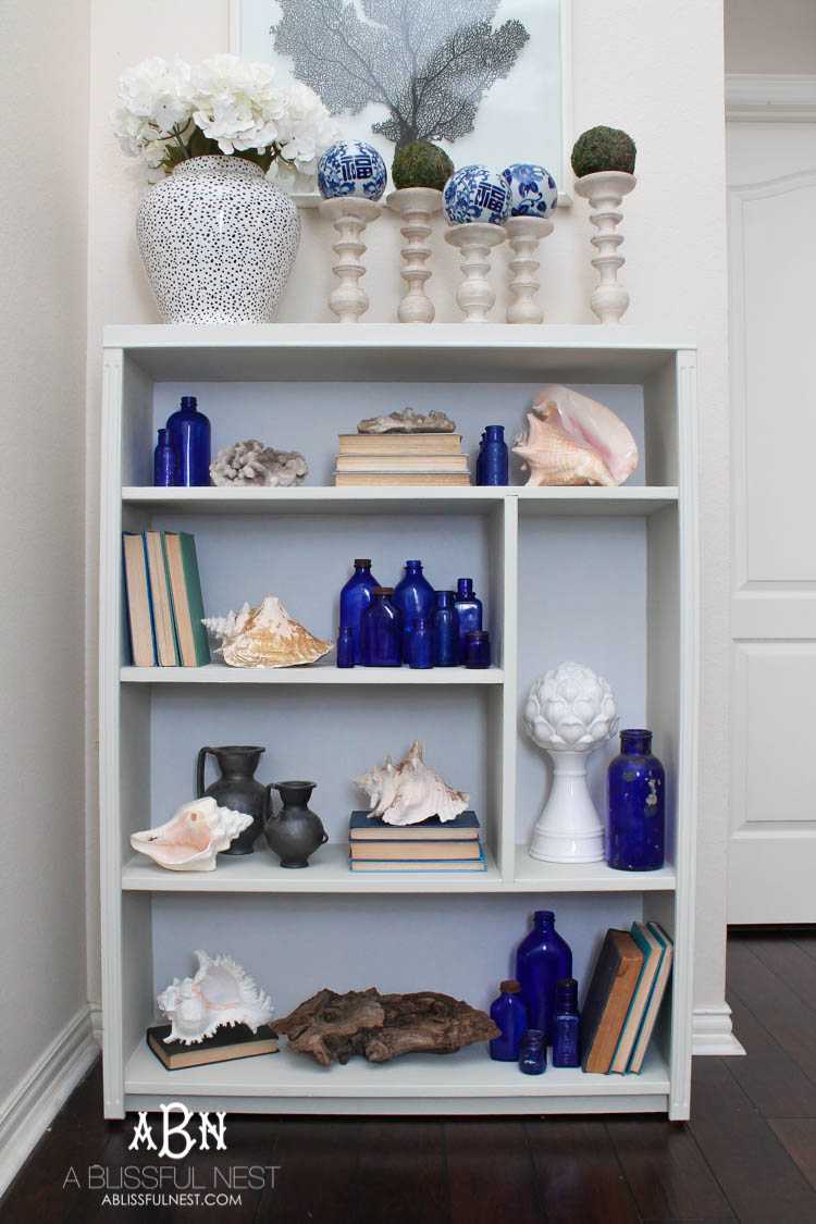 Got an old bookcase that needs to be updated? Checkout how this bookcase went from boring to fabulous with just a few easy steps! See more on https://ablisfulnest.com/ #bookcasemakeover #diybookcase #chalkfurniturepaint