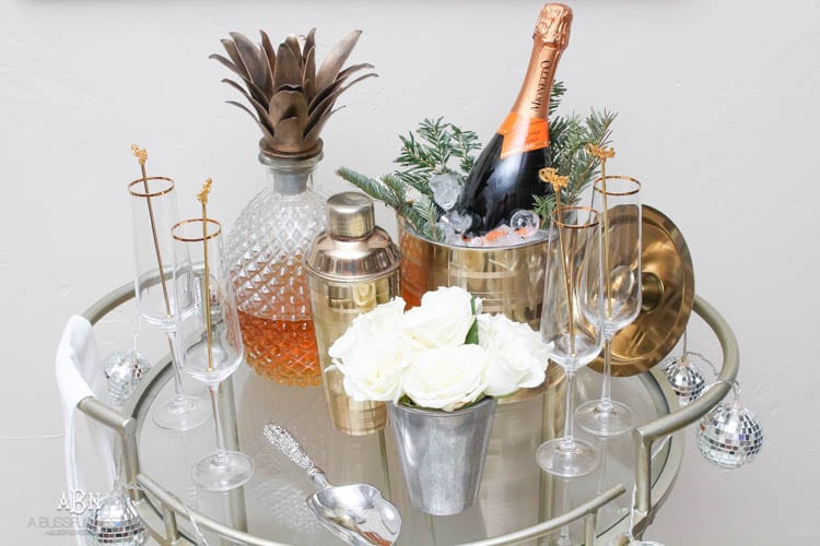 These are such great ideas to transition your Christmas décor into celebrating New Years Eve! Love all the gold and sparkly accents! See more on https://ablisfulnest.com/ #newyearseve #newyearsbarcart #ad #Pier1Love