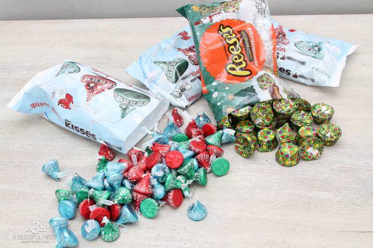 Wrap your presents in chocolaty goodness with Hershey’s Kisses! This is such a fun and unique idea to decorate a gift. Then they can eat the candy later after the present has been opened! So fun! See more on https://ablisfulnest.com/ #hersheyskiss #christmascraft #christmasdiyidea