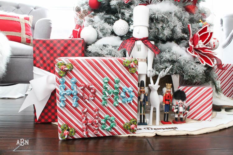 Wrap your presents in chocolaty goodness with Hershey’s Kisses! This is such a fun and unique idea to decorate a gift. Then they can eat the candy later after the present has been opened! So fun! See more on https://ablisfulnest.com/ #hersheyskiss #christmascraft #christmasdiyidea