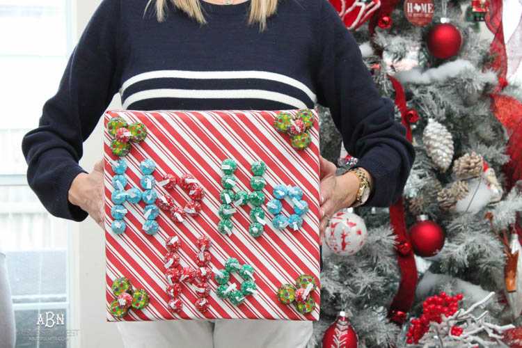 Wrap your presents in chocolaty goodness with Hershey’s Kisses! This is such a fun and unique idea to decorate a gift. Then they can eat the candy later after the present has been opened! So fun! See more on https://ablisfulnest.com/ #hersheyskiss #christmascraft #christmasdiyidea