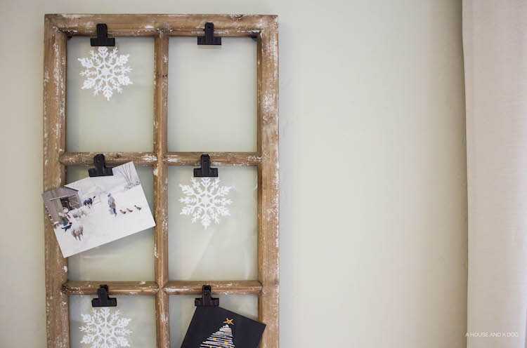 Use an old window and some clips to create a one-of-a-king Christmas card display. It makes for a beautiful decor piece in your home! See it all on https://ablisfulnest.com/ #Christmas #CHristmasCards #VintageDecor