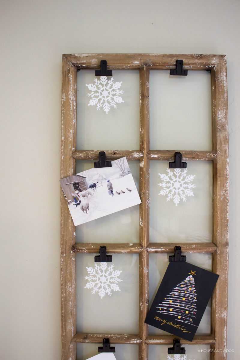 Use an old window and some clips to create a one-of-a-king Christmas card display. It makes for a beautiful decor piece in your home! See it all on https://ablisfulnest.com/ #Christmas #CHristmasCards #VintageDecor