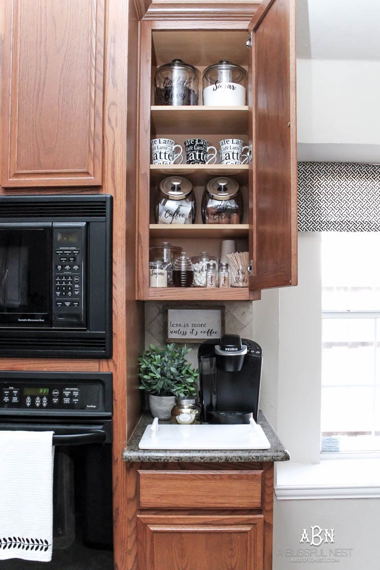 This is such a great idea! Transform a dead cabinet space with these coffee cabinet organization ideas! See more on https://ablisfulnest.com/ #coffee #coffeestation