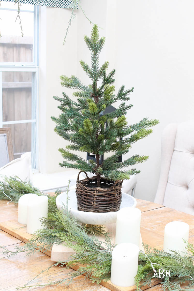 A classic christmas porch and beautiful neutral Christmas dining room idea. See more on https://ablisfulnest.com/ #christmasdecor #christmasideas #christmasfront porch #christmasdecoratingideas