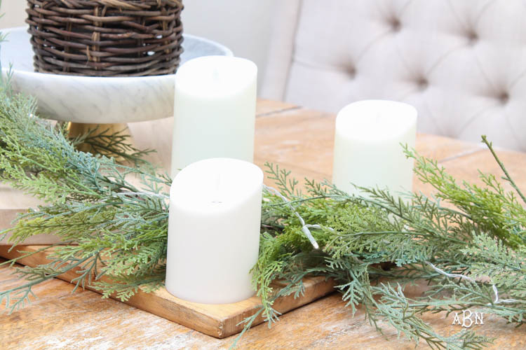 A classic christmas porch and beautiful neutral Christmas dining room idea. See more on https://ablisfulnest.com/ #christmasdecor #christmasideas #christmasfront porch #christmasdecoratingideas