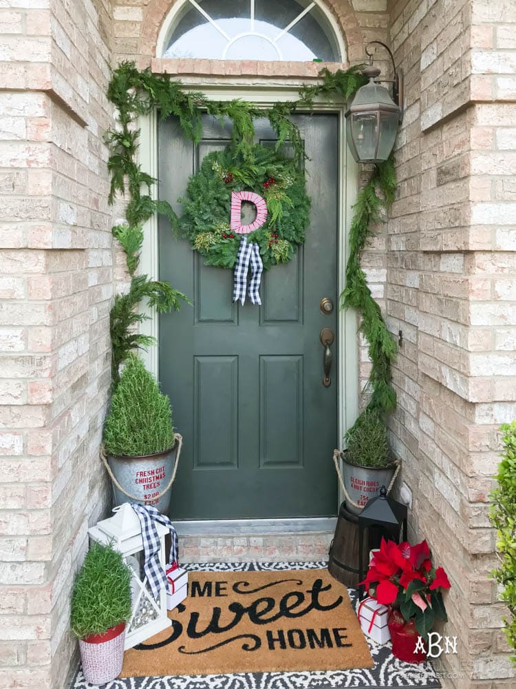 A classic christmas porch and beautiful neutral Christmas dining room idea. See more on https://ablisfulnest.com/ #christmasdecor #christmasideas #christmasfront porch #christmasdecoratingideas