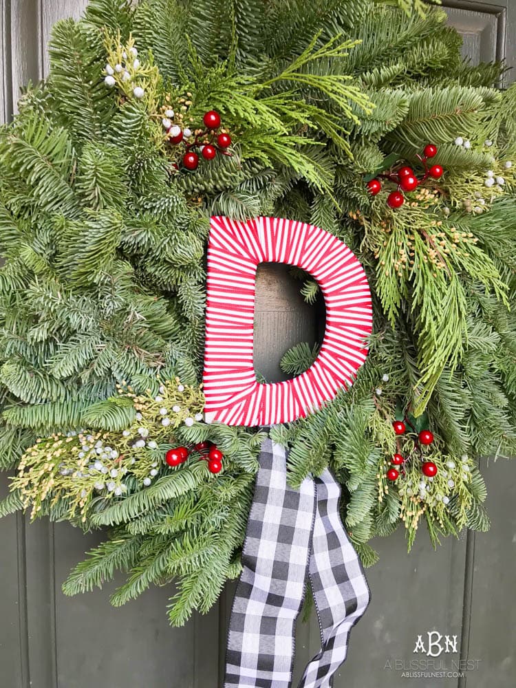A classic christmas porch and beautiful neutral Christmas dining room idea. See more on https://ablisfulnest.com/ #christmasdecor #christmasideas #christmasfront porch #christmasdecoratingideas
