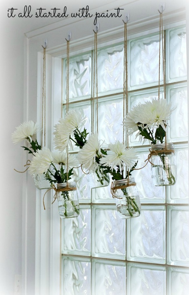 Bring fresh flowers indoors by hanging mason jars in front of the window! It All Started With Paint, 15 Things to do with Command Hooks in your Home via A Blissful Nest