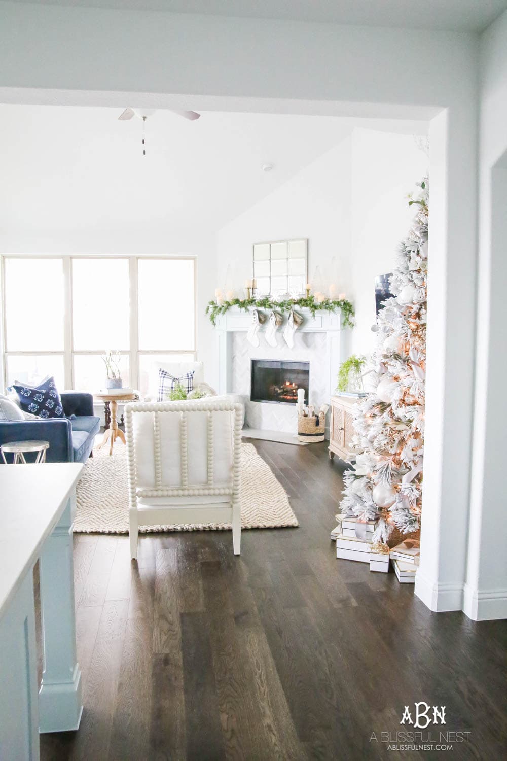Silver and gold Christmas tree in an open concept floor plan with lots of blue home decor accents. Check out all the white, silver and gold Christmas decor in this holiday home tour on ablisfulnest.com. #ABlissfulNest #Christmasdecor #Christmasdecorating #CoastalChristmasdecor #christmastree