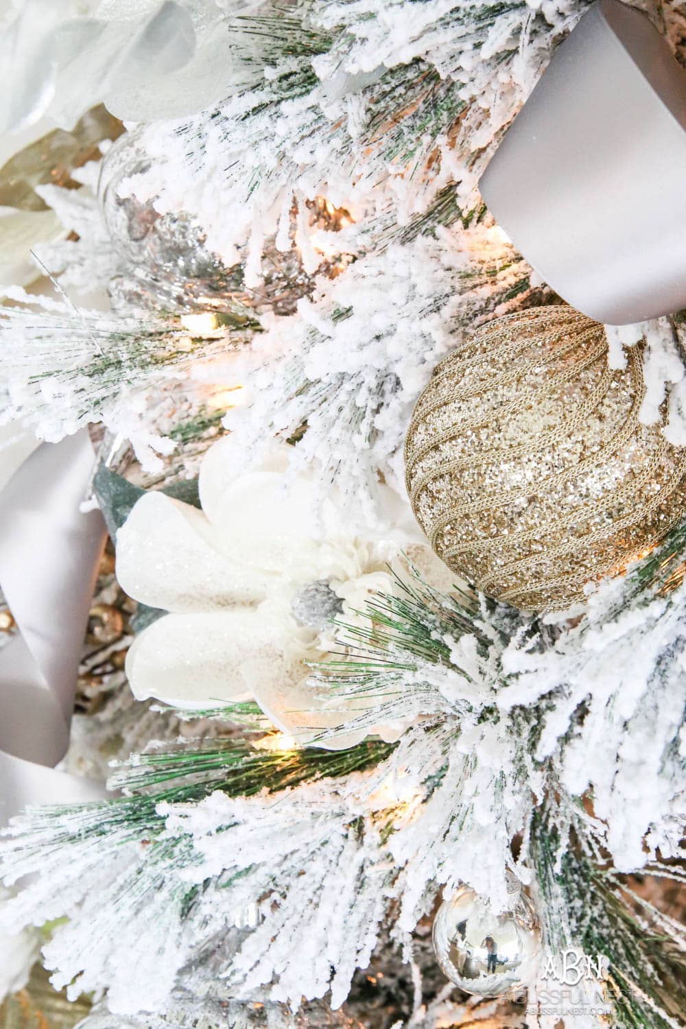 Silver and gold Christmas tree in an open concept floor plan with lots of blue home decor accents. Check out all the white, silver and gold Christmas decor in this holiday home tour on ablisfulnest.com. #ABlissfulNest #Christmasdecor #Christmasdecorating #CoastalChristmasdecor