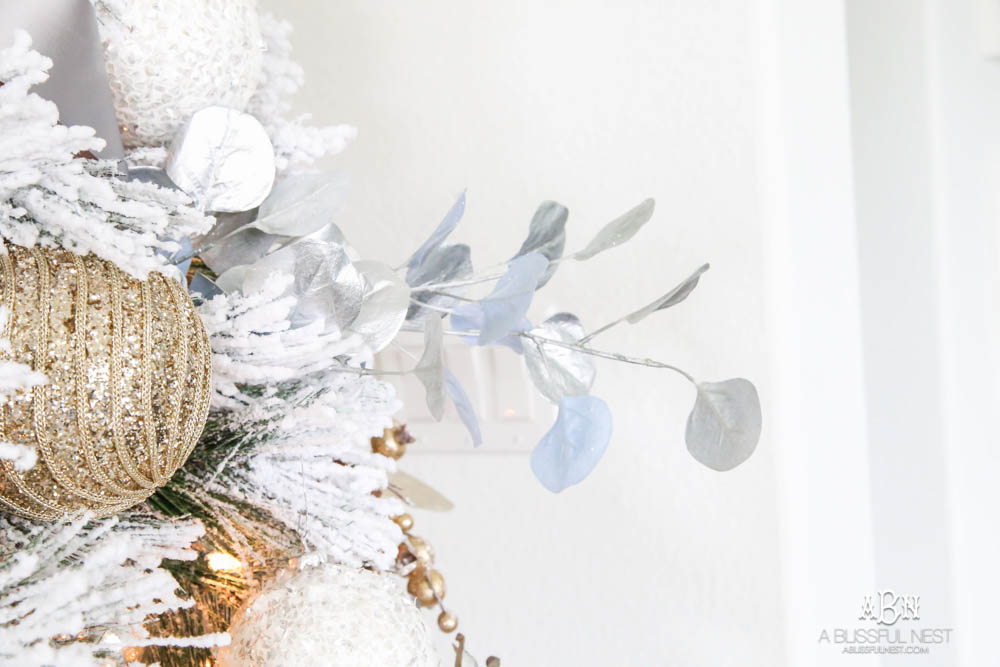 Silver and gold Christmas tree in an open concept floor plan with lots of blue home decor accents. Check out all the white, silver and gold Christmas decor in this holiday home tour on ablisfulnest.com. #ABlissfulNest #Christmasdecor #Christmasdecorating #CoastalChristmasdecor
