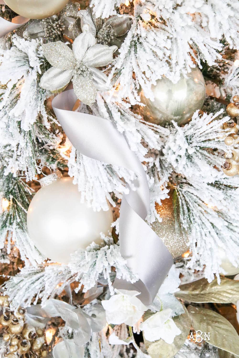 Silver and gold Christmas tree in an open concept floor plan with lots of blue home decor accents. Check out all the white, silver and gold Christmas decor in this holiday home tour on ablisfulnest.com. #ABlissfulNest #Christmasdecor #Christmasdecorating #CoastalChristmasdecor #christmastree