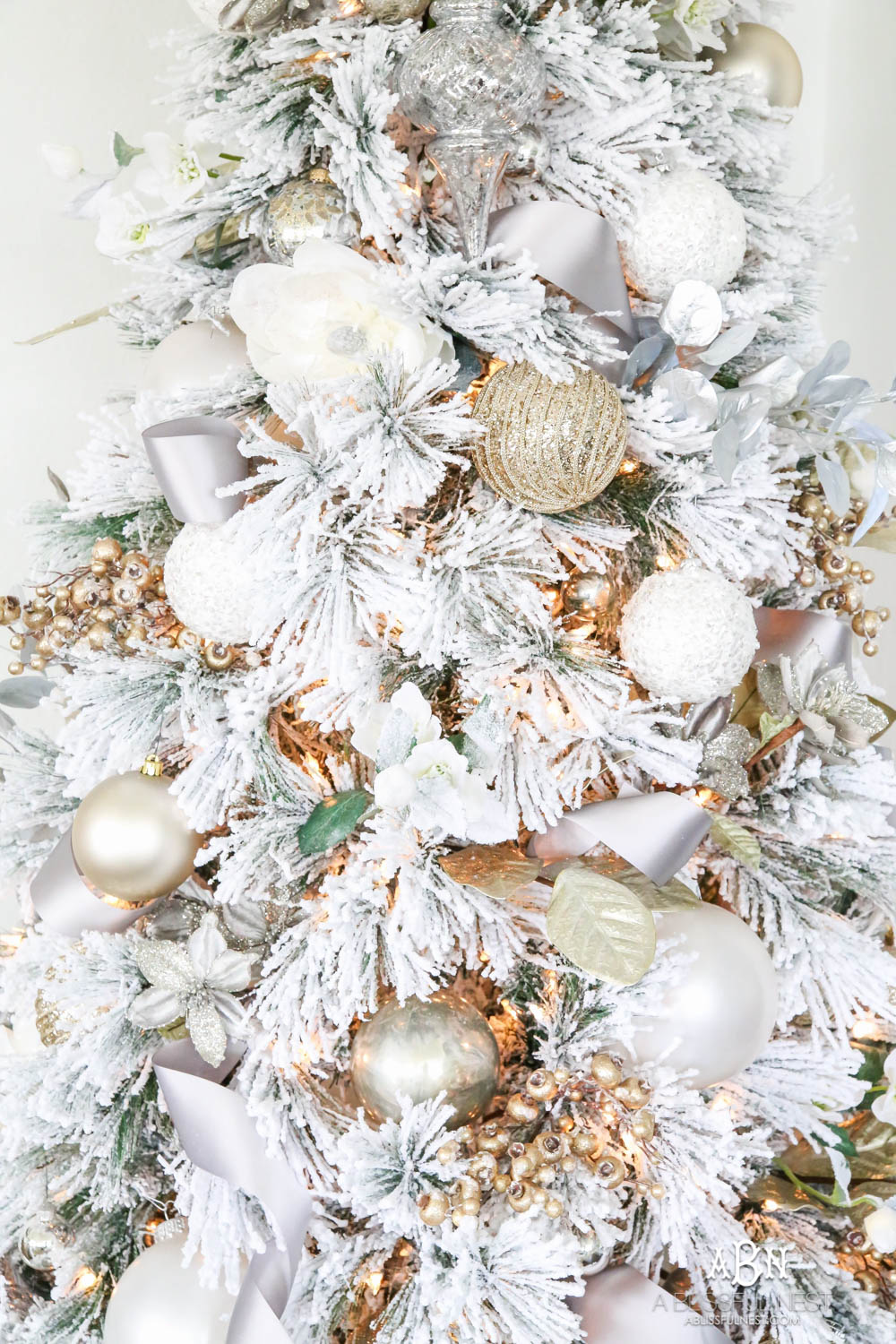 Silver and gold Christmas tree in an open concept floor plan with lots of blue home decor accents. Check out all the white, silver and gold Christmas decor in this holiday home tour on ablisfulnest.com. #ABlissfulNest #Christmasdecor #Christmasdecorating #CoastalChristmasdecor