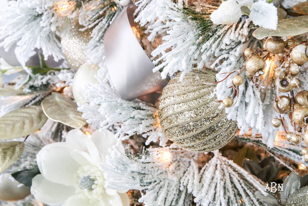 Silver and gold Christmas tree in an open concept floor plan with lots of blue home decor accents. Check out all the white, silver and gold Christmas decor in this holiday home tour on ablisfulnest.com. #ABlissfulNest #Christmasdecor #Christmasdecorating #CoastalChristmasdecor