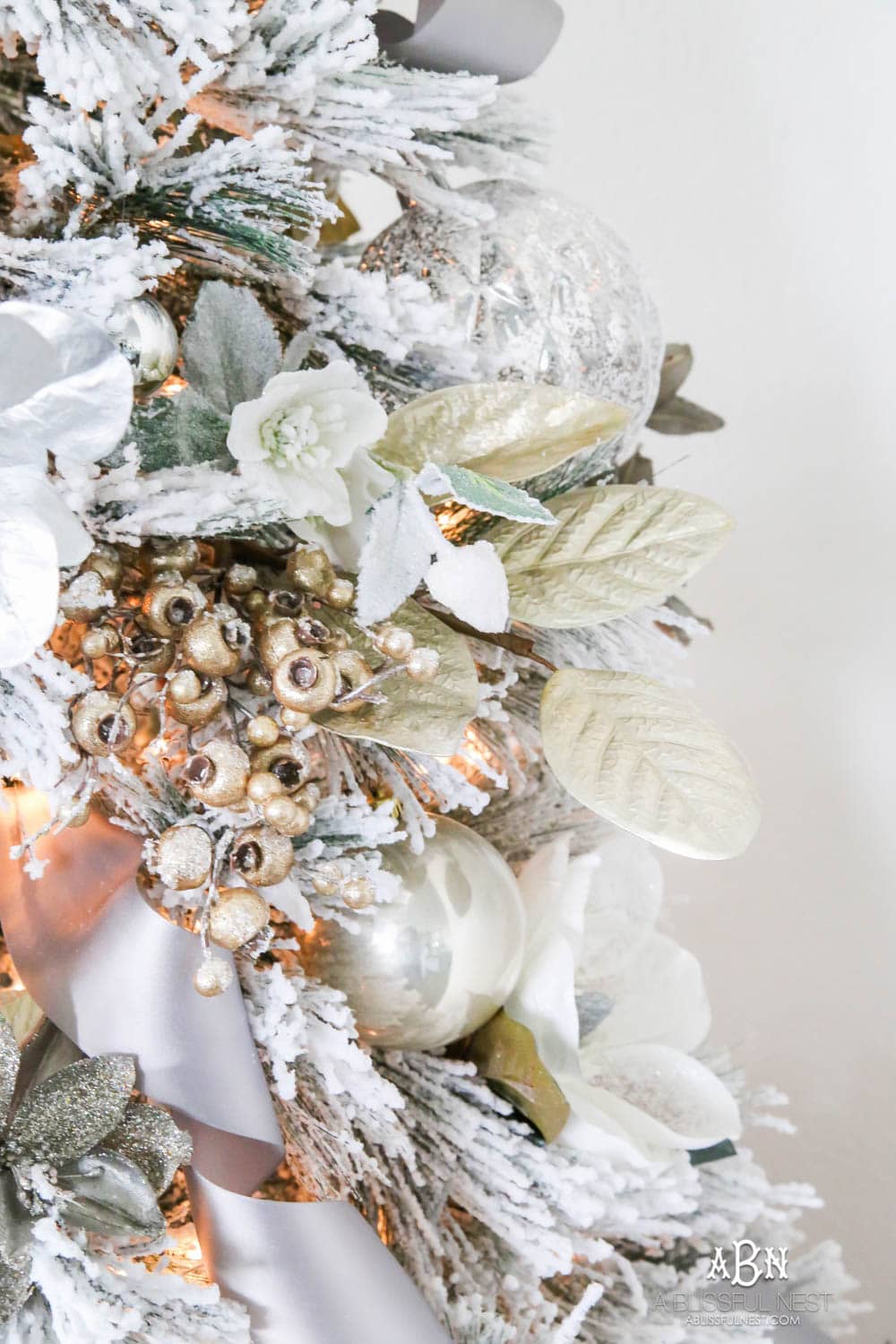 Silver and gold Christmas tree in an open concept floor plan with lots of blue home decor accents. Check out all the white, silver and gold Christmas decor in this holiday home tour on ablisfulnest.com. #ABlissfulNest #Christmasdecor #Christmasdecorating #CoastalChristmasdecor