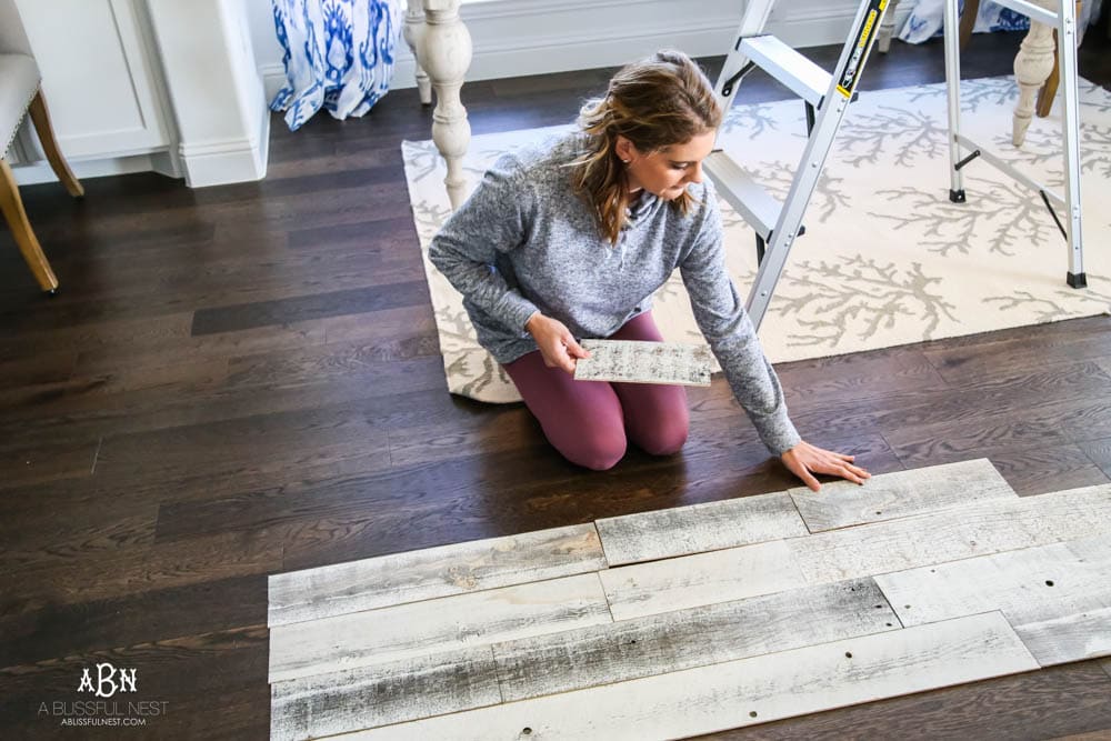 This is the simplest and easy way to install farmhouse barnwood on a ceiling! Just peel and stick these boards from Stikwood for a dramatic makeover to your plain ceiling or wall. More details on https://ablisfulnest.com #farmhousedecor #farmhouseproject #farmhousestyle #ad #stikwood