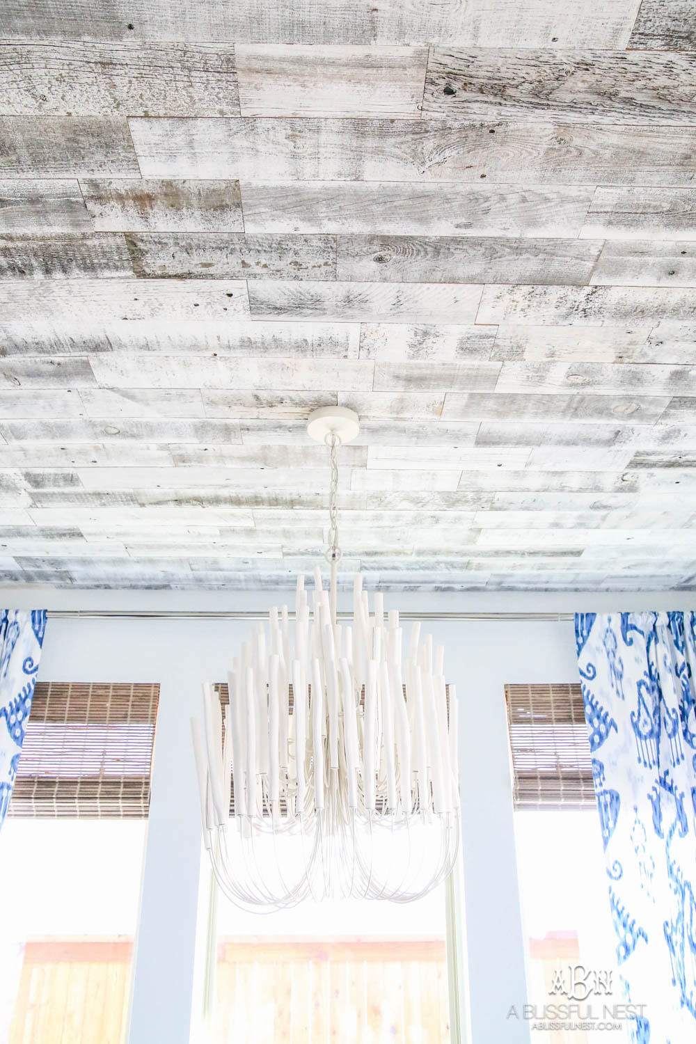 This is the simplest and easy way to install farmhouse barnwood on a ceiling! Just peel and stick these boards from Stikwood for a dramatic makeover to your plain ceiling or wall. More details on https://ablisfulnest.com #farmhousedecor #farmhouseproject #farmhousestyle #ad #stikwood