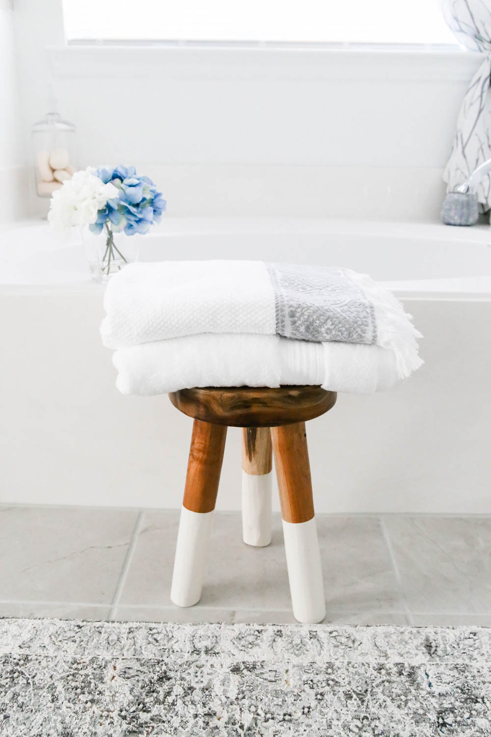 Add fresh towels and layer with different patterns in a bathroom refresh. #AtHomeStores #AtHomeFinds #ad
