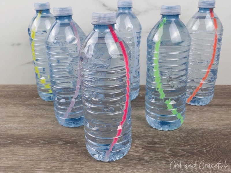 plastic water bottles with glow in the dark sticks inside them