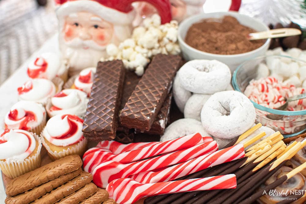 Peppermint spoons, chocolate wafer bars, and donuts on a cutting board