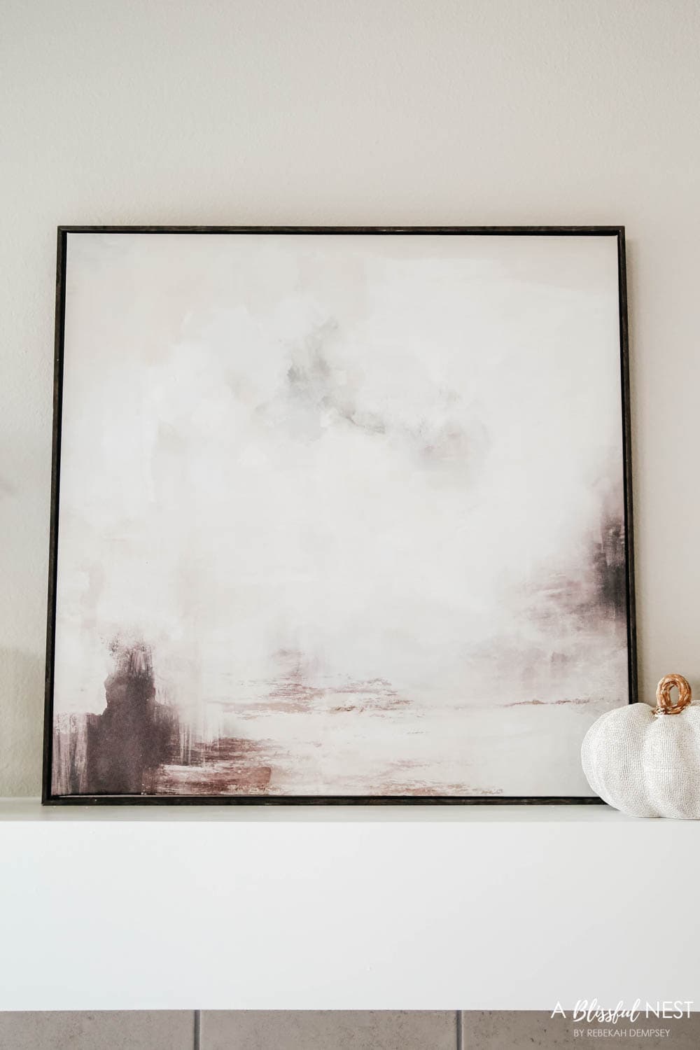 Moody artwork above a fireplace mantle